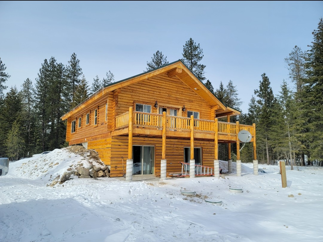 Two-story log home in winter snow