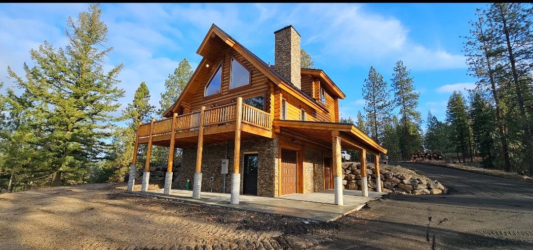 Beautiful stone chimney on a log home